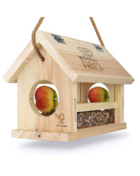 An image of a natural wooden bird feeder with integral apple feeders and seed or nut compartment. Build to resemble a house with a hinged apex roof.