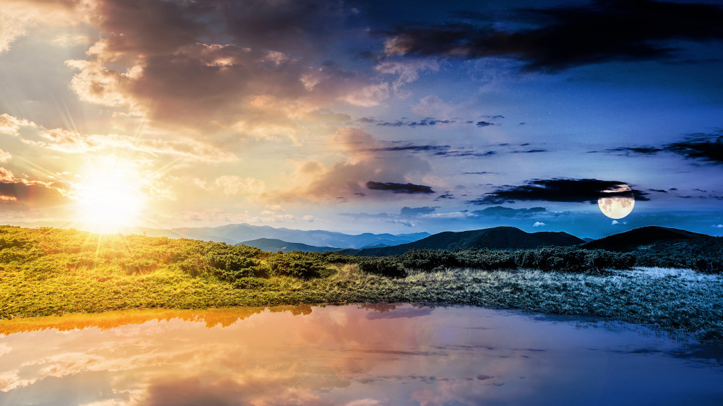 An image of a fantasy representation of an equinox featuring the sun and a moon in alignment depicting the equal length of day and night. September equinox.