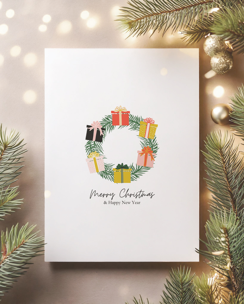 Image of a Christmas card featuring artwork available in this free offer. The hand drawn artwork features an evergreen wreath decorated with presents.