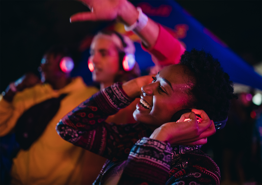 Image of people wearing headphones dancing and enjoy a "Silent Disco".