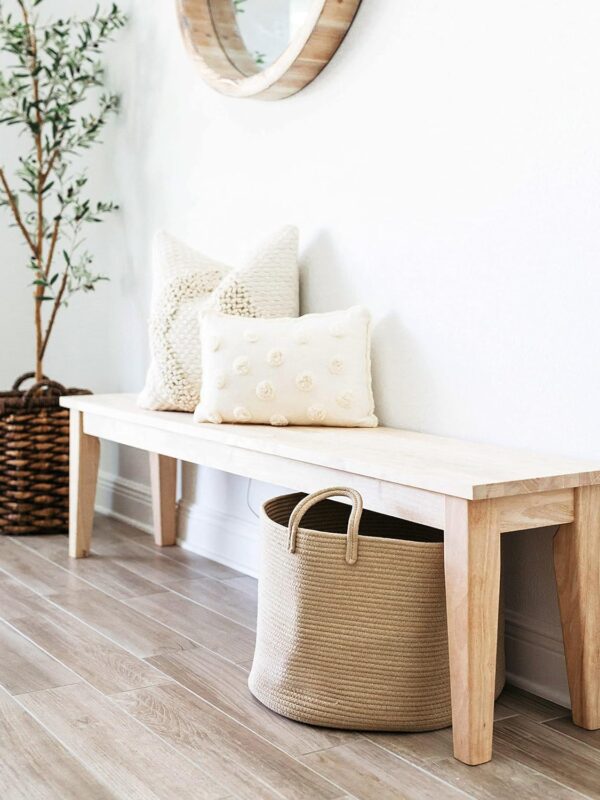 Image of a large woven storage basket used under a bench in a hallway. Available to buy from Amazon.