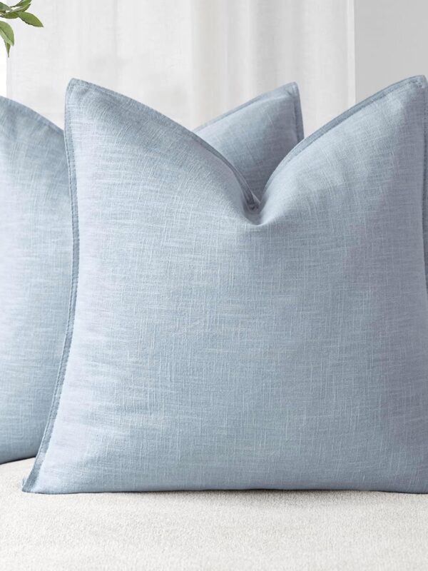 Image of a set of two Light Blue Linen Look Cushions on a sofa. Please note, the item is for the cushion covers only, cushion pad is not included. Available to buy from Amazon.