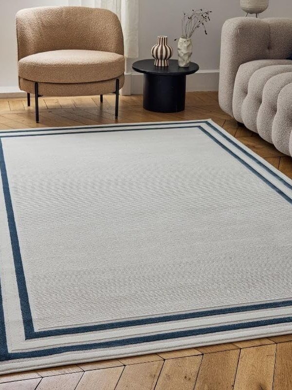 An alternative image of the Navy Blue Border Rug in a living room setting. Available to buy from Amazon.