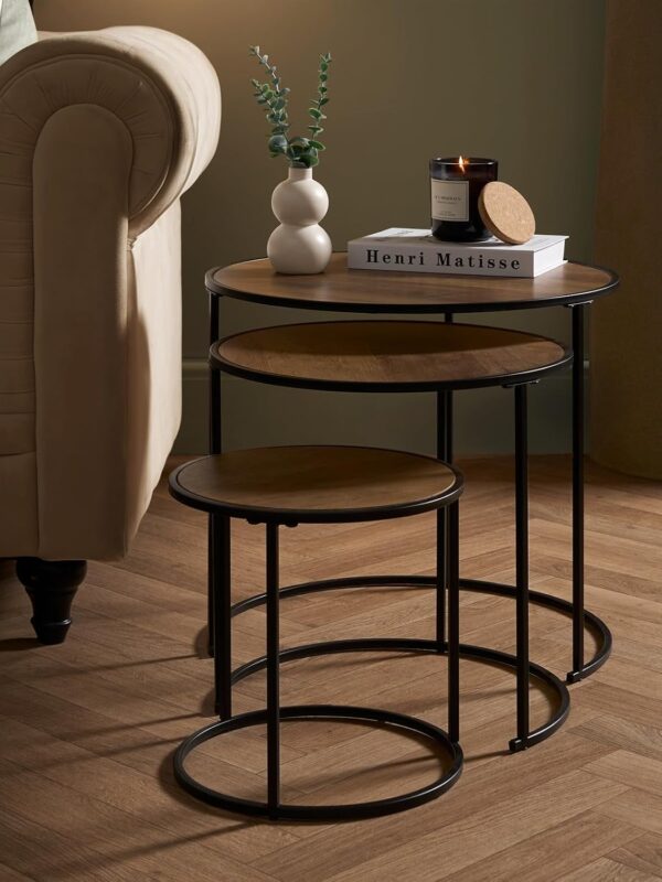Set of nesting tables. Dark wood round table tops and black metal frame.