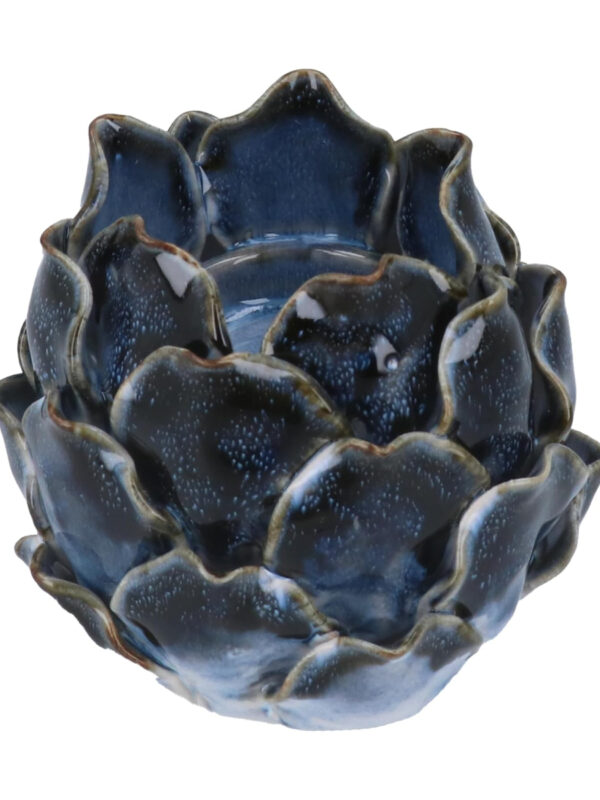Blue ceramic artichoke tea light holder with layered glazed leaves and speckled finish on a white background